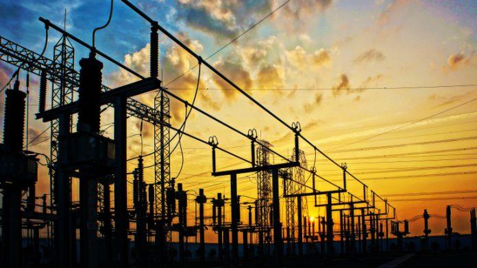 Electricity network at transformer station in sunrise