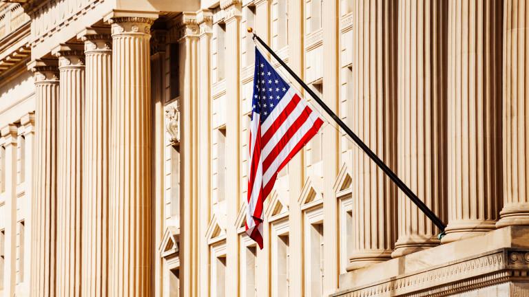 US flag over government building in Washington, DC