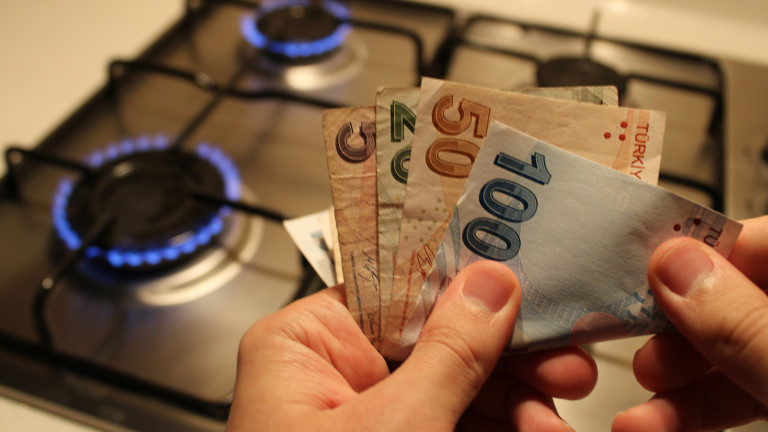 man hand counting money. gas stove in the background. high gas bill.high electricity and gas prices, economic crisis