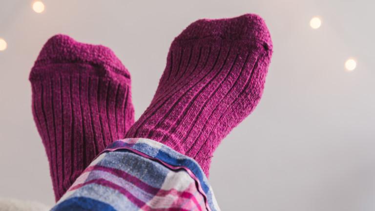 Feet up in pink socks crossed over each other