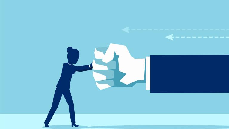 Vector of a woman fighting back a giant fist, protecting herself from work abuse
