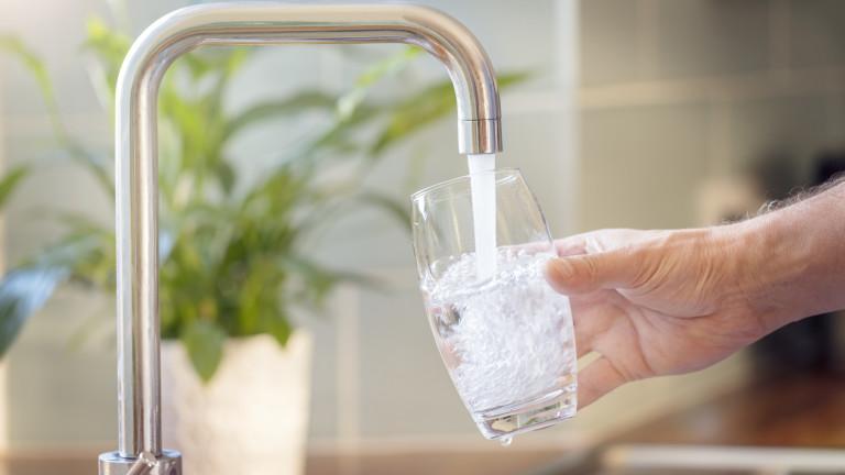 Filling up a glass with drinking water from kitchen tap