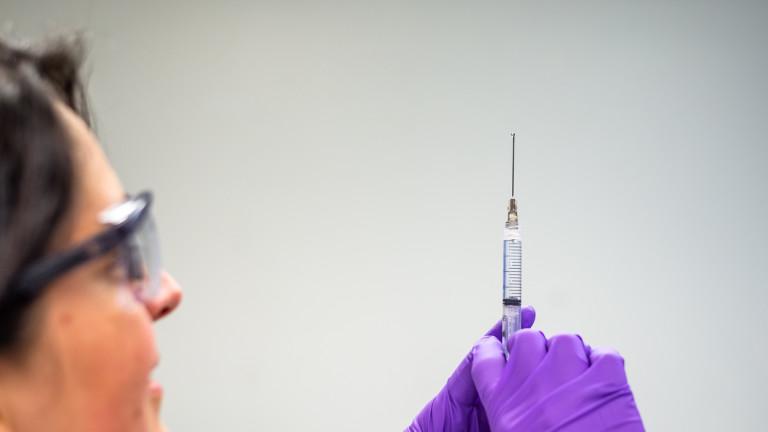 Doctor drawing vaccine and injection in syringe
