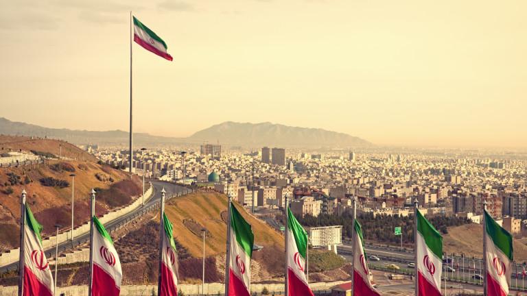 Row of Iran Flags in Front of Tehran Skyline