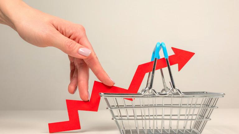 The fingers of a woman's hand step up the arrow of a chart lying on a shopping basket. Crisis and rising commodity prices concept