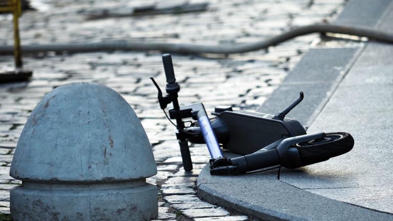 Broken scooter on the road after an accident