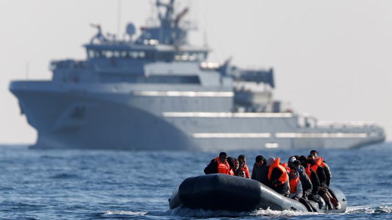 Migrants cross the English Channel on a small boat
