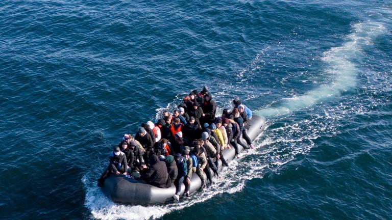 Migrants cross the English Channel on a small boat