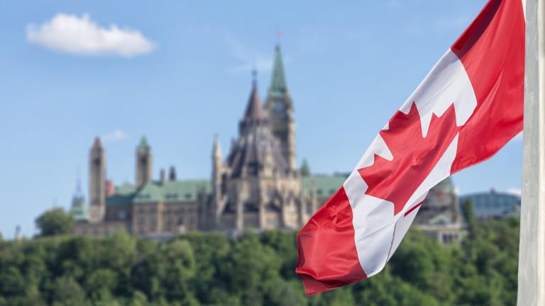 Canadian flag waving with Parliament Buildings hill and Library