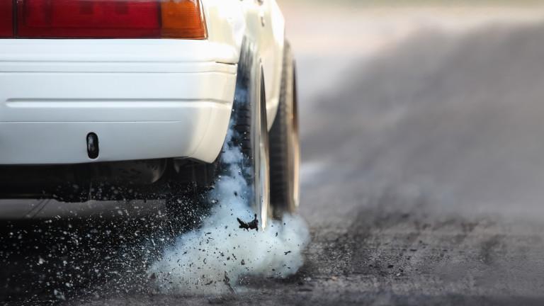 Drag racing car burns rubber off its tires in preparation for the race