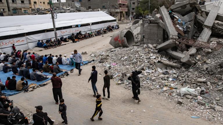 Gaza displaced Palestinians perform Friday prayer near mosque ruins in Rafah