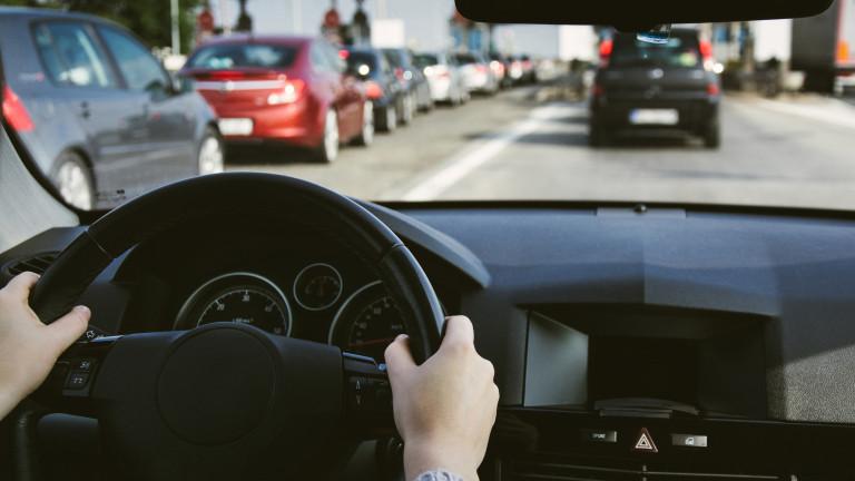 Driving car on the road. Hands on steering wheel inside of a car