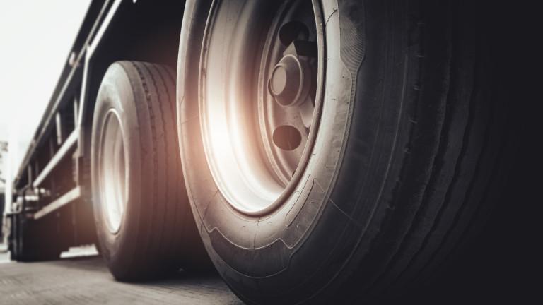 Freight transportation. Close up large a truck wheels and tires of semi truck.