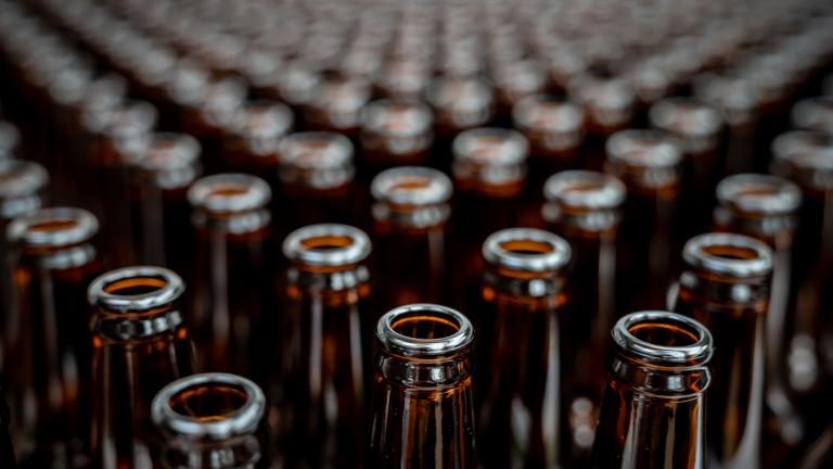 Close up on empty bottles ready to be filled at a beer factory