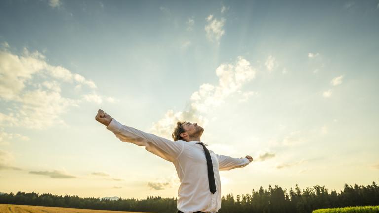 Thankful Businessman with Open Arms at the Field